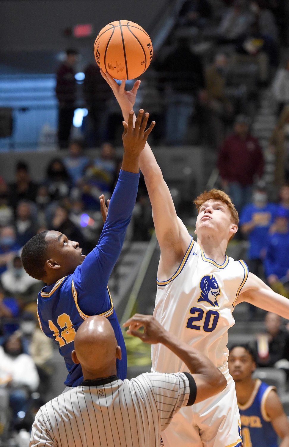 Kemper County's Jamar Grace (12) jumps at ceenter against Booneville's Josh Dukes at the MHSAA State Basketball Tournament  semifinals on Wednesday, March 3, 2021, at the Mississippi Coliseum in Jackson, Miss..