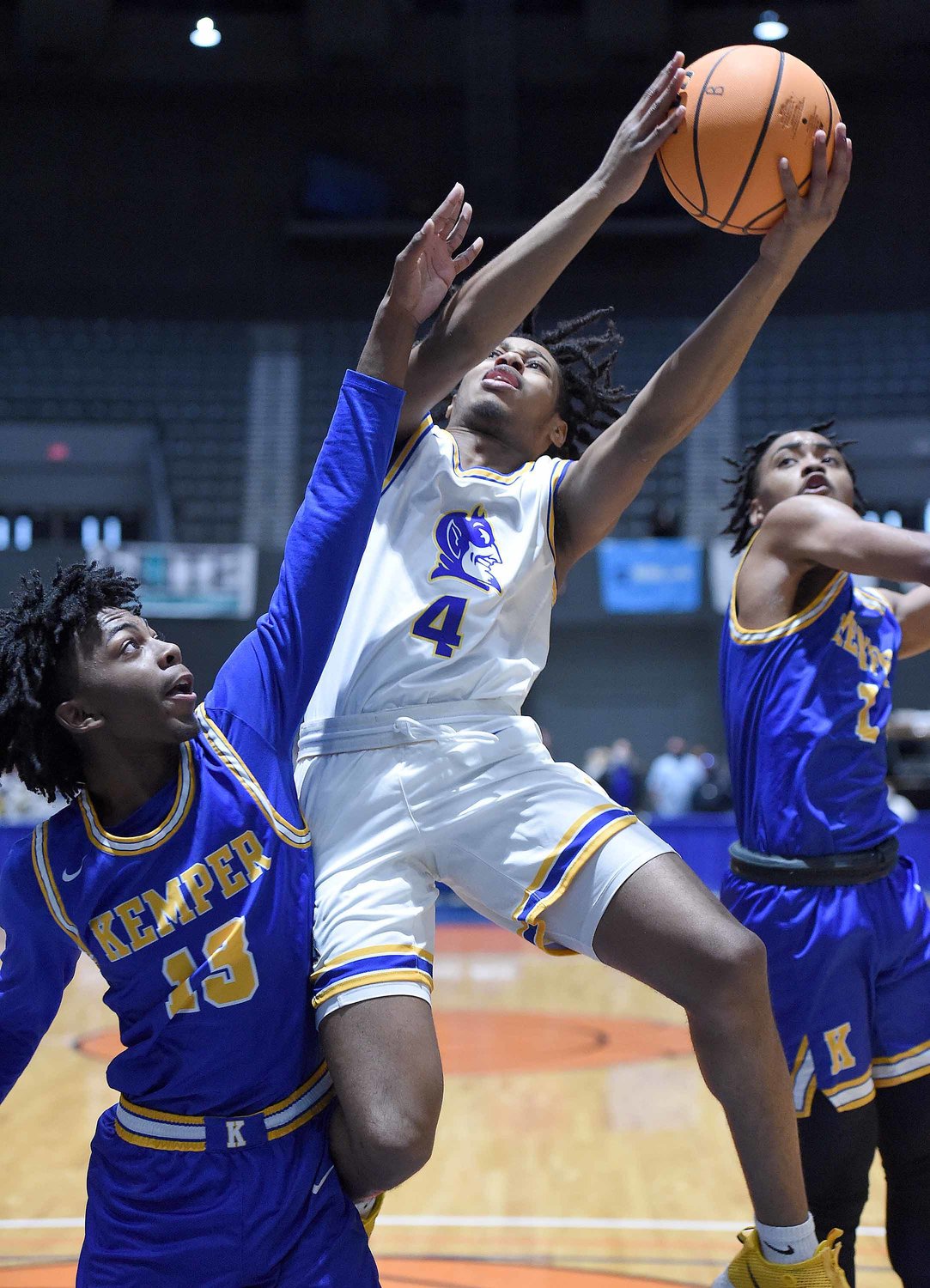 Kemper County's Aiden Bourrage (13) defends against Booneville's Dicorean McGee (4) at the MHSAA State Basketball Tournament  semifinals on Wednesday, March 3, 2021, at the Mississippi Coliseum in Jackson, Miss.