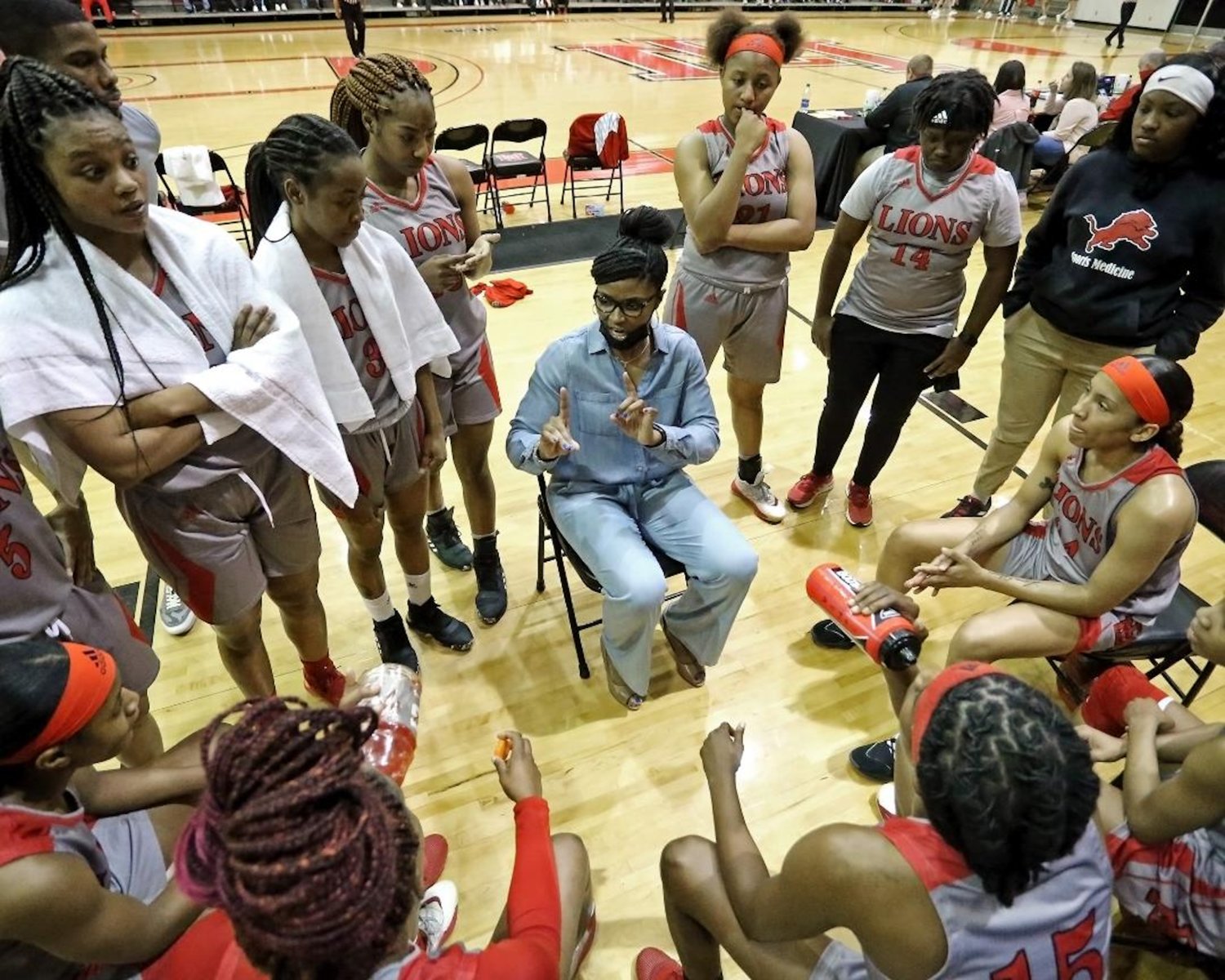 Coach Sharon Thompson’s East Mississippi Lady Lions listen up during a timeout in an earlier game. In the other photo, Ja’Mia Hollings takes a shot in an earlier game. The Lady Lions were 12-4 when they played Coahoma in the semifinals Wednesday at Mississippi College.