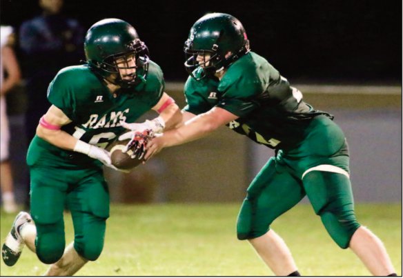 Eli Weaver (22) hands to ball off to Eli Miles (16) in Kemper Academy's Friday night football action.