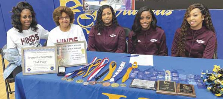 Kemper County High School track standout Brynesha Bourrage signs a letter of intent to run for Hinds Community College next year as members of her family look on during a Monday morning press conference at the KCHS gym. Pictured are: from left, Briana Turner, sister; Valarie Turner, grandmother; Shannon Jackson, mother; Brynesha Bourrage, athlete; and z Hampton, sister.