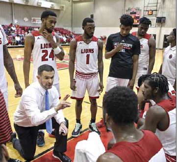 EMCC head coach Billy Begley discusses strategy with his team during a home game this season.
