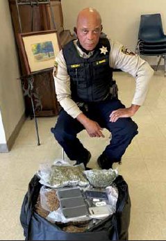 Kemper County Sheriff James Moore displays some of the contraband that
was recently attempted to be smuggled into the Kemper/Neshoba County
Regional Correctional Facility.