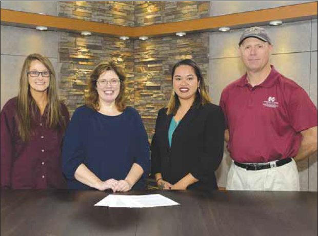Mississippi Band of Choctaw Indians spokesperson Tia Grisham, third from left, joins Mississippi State University Extension personnel Kaiti Ford, Mariah Morgan and Jim McAdory in reviewing a memorandum of understanding that will strengthen partnerships between the tribe and MSU.
